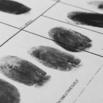 Series of inked finger prints on identification card