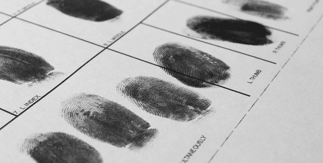 Series of inked finger prints on identification card