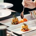 Food being prepared on white plates