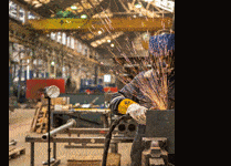 An engineer welding in an industrial workshop