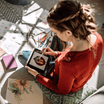 woman drawing on a digital tablet device.