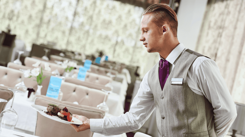 Person serving food in hotel livery