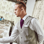 Person serving food in hotel livery